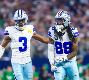 Dallas Cowboys wide receiver George Pickens puts a hand on the back of teammate CeeDee Lamb, who yells and clenches his fists.