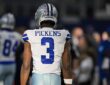 Dallas Cowboys wide receiver George Pickens stands with his back to the camera in his No. 3 jersey before kickoff.