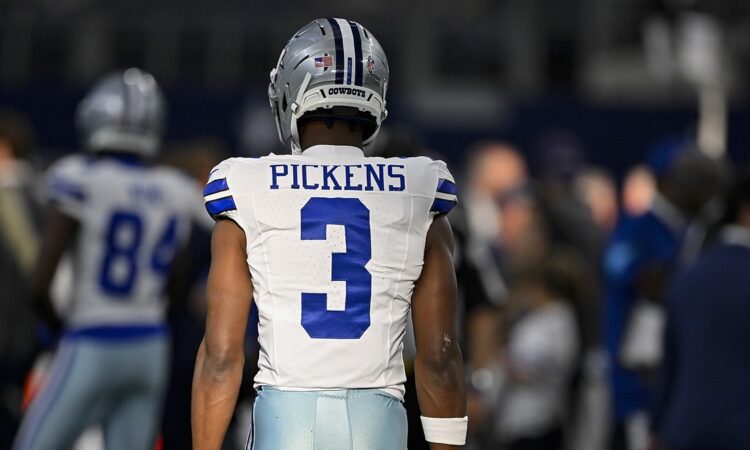 Dallas Cowboys wide receiver George Pickens stands with his back to the camera in his No. 3 jersey before kickoff.