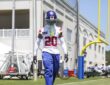 New York Giants cornerback Greg Newsome II, No. 20, walks the sideline in helmet and practice jersey at camp.