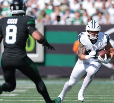 Dallas Cowboys running back Hunter Luepke cuts upfield with the ball as New York Jets safety Andre Cisco closes in.