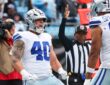 Dallas Cowboys running back Hunter Luepke yells with clenched fists as a teammate approaches and an official raises his arm.