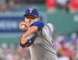 Texas Rangers starting pitcher Jack Leiter rears back to throw a pitch in his gray road uniform.