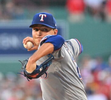 Texas Rangers starting pitcher Jack Leiter rears back to throw a pitch in his gray road uniform.