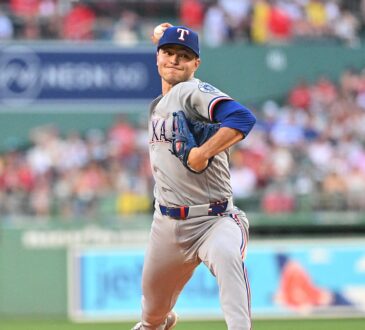 Texas Rangers starting pitcher Jack Leiter, No. 22, drives toward the plate mid-delivery.