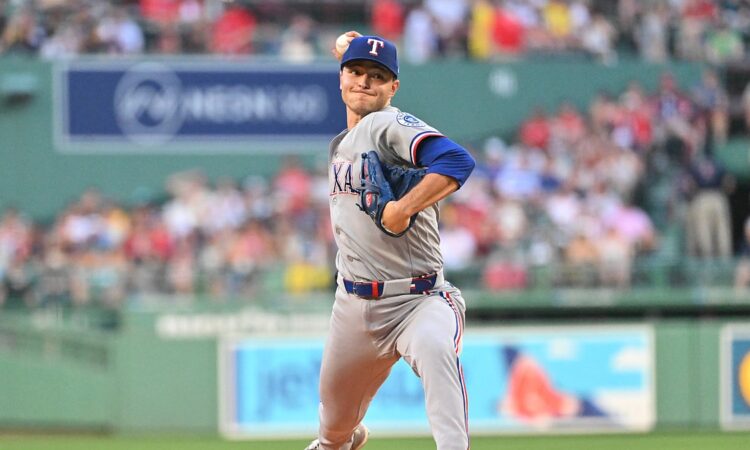 Texas Rangers starting pitcher Jack Leiter, No. 22, drives toward the plate mid-delivery.