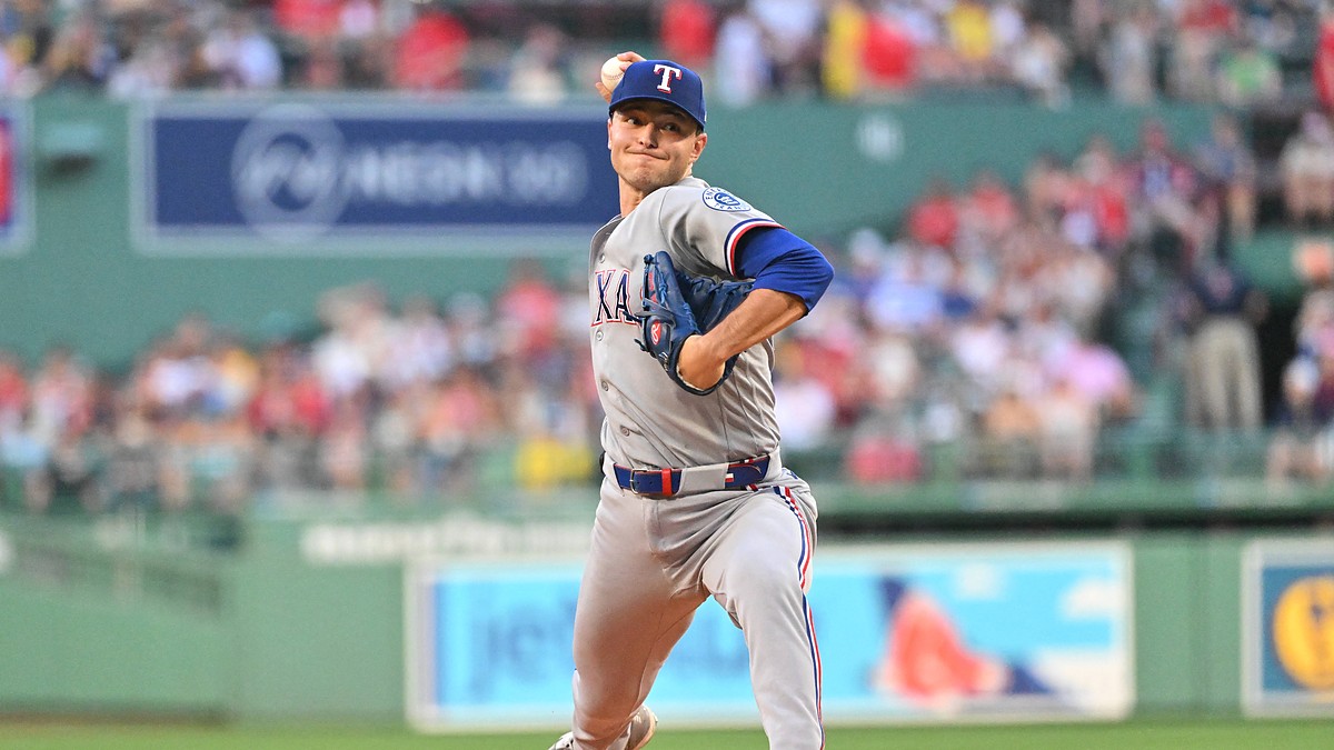 Texas Rangers starting pitcher Jack Leiter, No. 22, drives toward the plate mid-delivery.