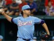 Texas Rangers starting pitcher Jacob deGrom winds up to deliver a pitch in a powder blue uniform.