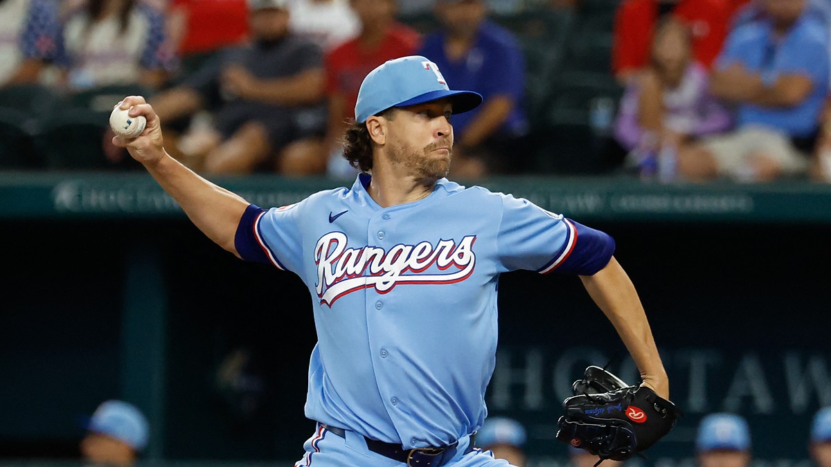 Texas Rangers starting pitcher Jacob deGrom winds up to deliver a pitch in a powder blue uniform.