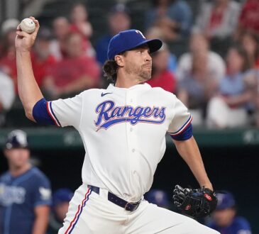 Texas Rangers right-hander Jacob deGrom, No. 48, brings his arm forward to deliver a pitch.