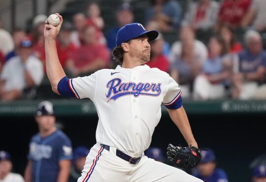 Texas Rangers right-hander Jacob deGrom, No. 48, brings his arm forward to deliver a pitch.