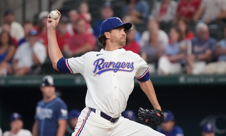 Texas Rangers right-hander Jacob deGrom, No. 48, brings his arm forward to deliver a pitch.