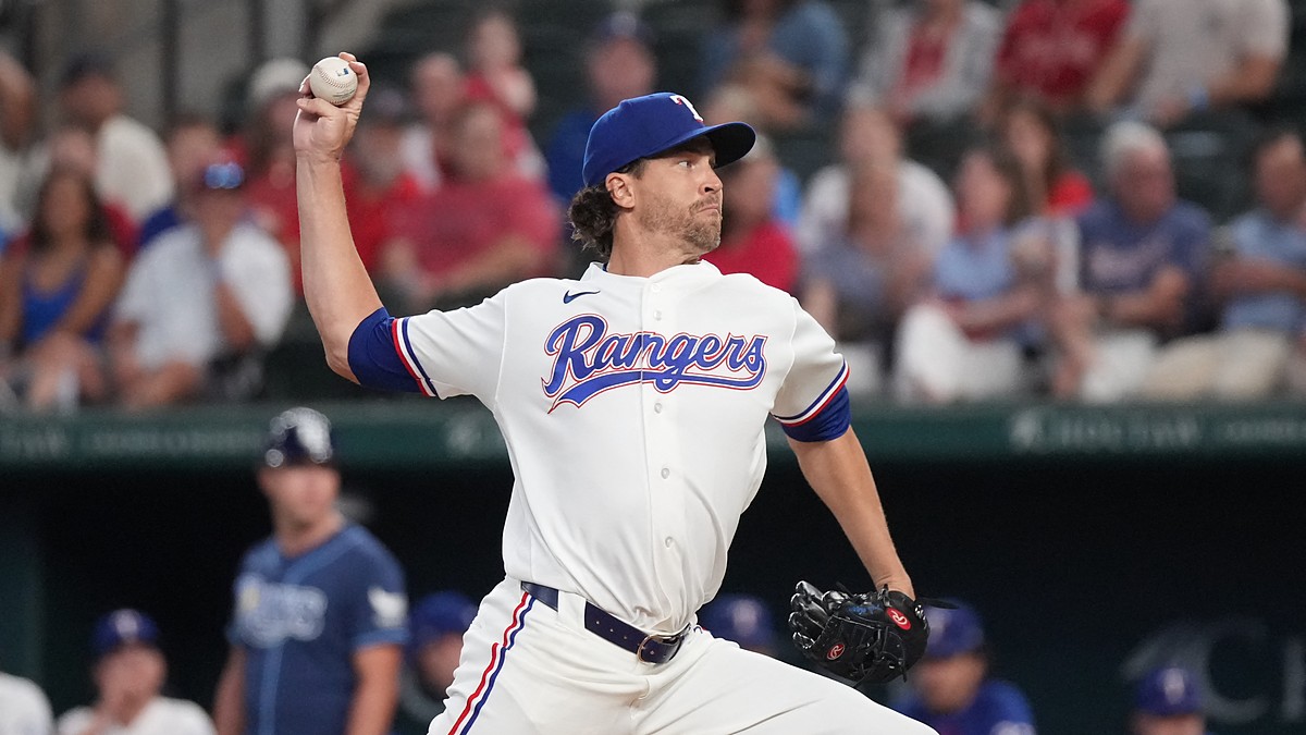 Texas Rangers right-hander Jacob deGrom, No. 48, brings his arm forward to deliver a pitch.