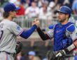 Texas Rangers pitcher Jacob Latz, No. 67, clasps hands with catcher Kyle Higashioka, No. 11, after a win.