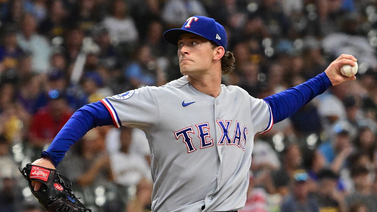 Texas Rangers left-hander Jacob Latz, No. 67, brings his arm back to deliver a pitch.