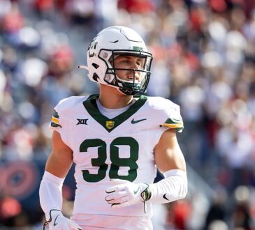Baylor Bears safety Jacob Redding, No. 38, stands on the field in a white road uniform.