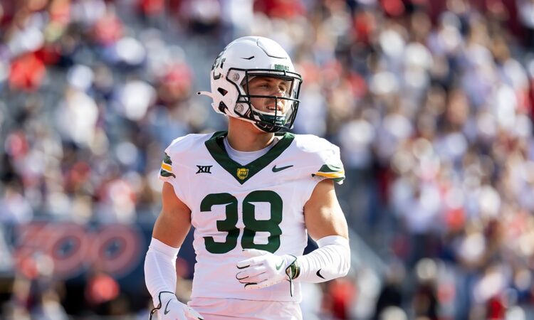Baylor Bears safety Jacob Redding, No. 38, stands on the field in a white road uniform.