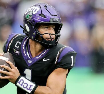 TCU quarterback Jaden Craig holds the ball at his chest and scans downfield during a rainy game.