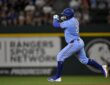 Texas Rangers first baseman Jake Burger pumps his fist as he rounds the bases after a home run at Globe Life Field.