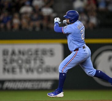 Texas Rangers first baseman Jake Burger pumps his fist as he rounds the bases after a home run at Globe Life Field.