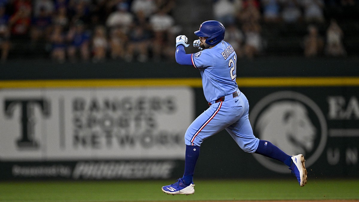 Texas Rangers first baseman Jake Burger pumps his fist as he rounds the bases after a home run at Globe Life Field.