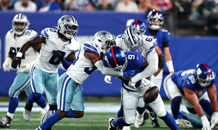 Cowboys safety Jalen Thompson and linebacker Donovan Ezeiruaku jar the ball loose from Giants tight end Isaiah Likely.