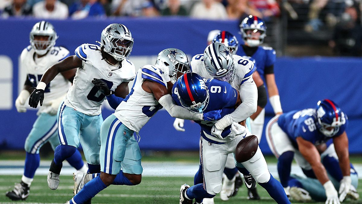 Cowboys safety Jalen Thompson and linebacker Donovan Ezeiruaku jar the ball loose from Giants tight end Isaiah Likely.