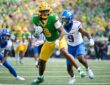 Oregon Ducks tight end Jamari Johnson runs with the ball as Boise State safety Derek Ganter Jr. pursues him.