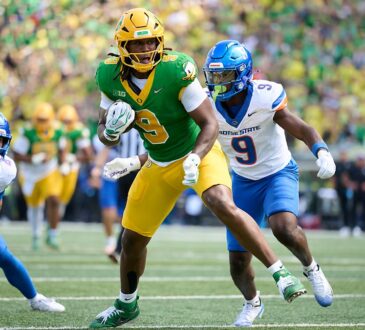 Oregon Ducks tight end Jamari Johnson runs with the ball as Boise State safety Derek Ganter Jr. pursues him.