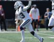 Dallas Cowboys defensive end James Houston raises a hand as he celebrates after a sack.