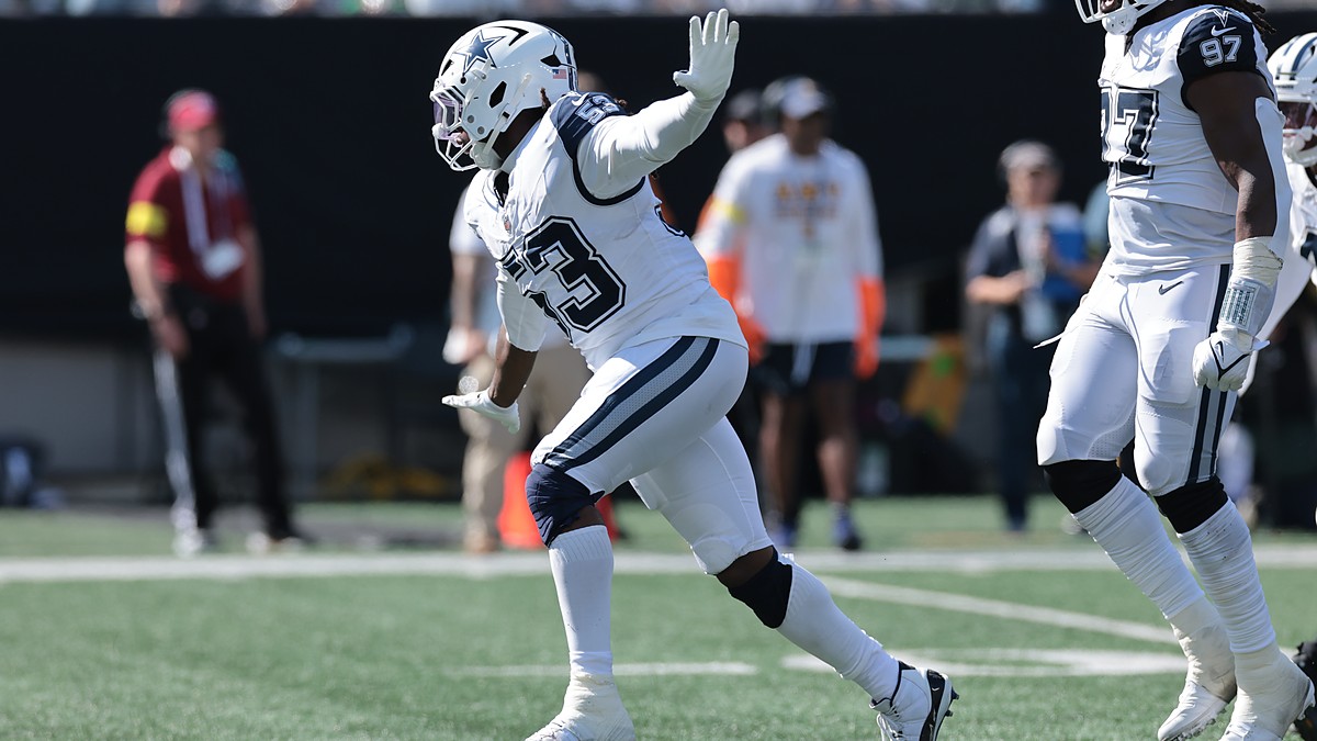 Dallas Cowboys defensive end James Houston raises a hand as he celebrates after a sack.