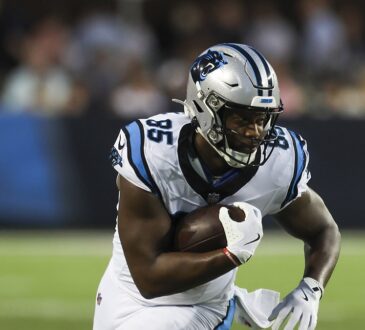 Carolina Panthers tight end James Mitchell tucks the ball and turns upfield at Tom Benson Hall of Fame Stadium.