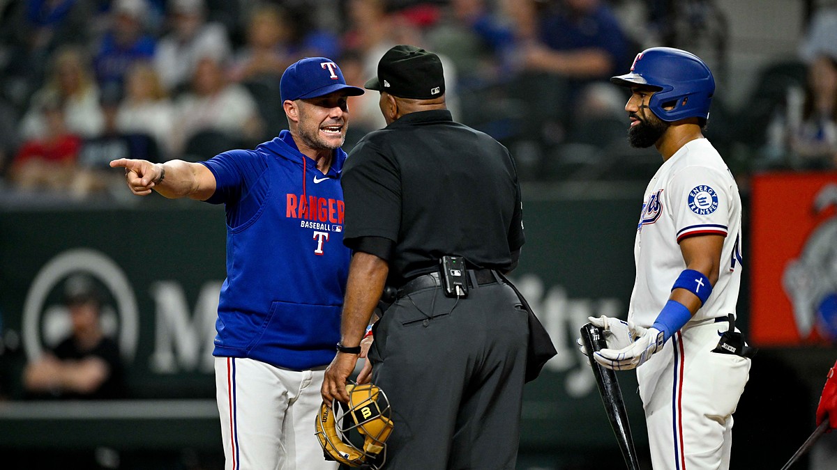 Texas Rangers shortstop Ezequiel Duran, No. 20, and manager Jared “Skip” Schumaker, No. 55, argue a called strike with home plate umpire Laz Diaz during the ninth inning against the New York Mets at Globe Life Field in Arlington, Texas, on Sept. 22, 2026.