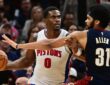 Cleveland Cavaliers center Jarrett Allen reaches around Pistons center Jalen Duren, who holds the ball away.