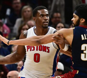 Cleveland Cavaliers center Jarrett Allen reaches around Pistons center Jalen Duren, who holds the ball away.