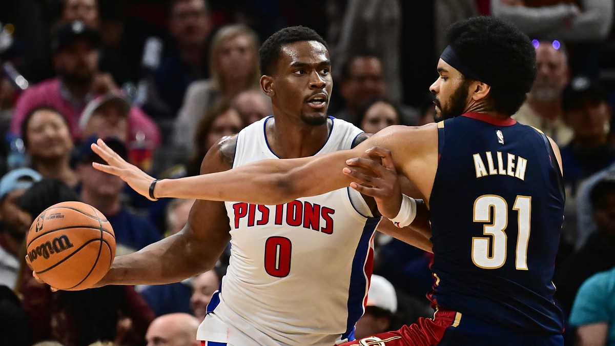 Cleveland Cavaliers center Jarrett Allen reaches around Pistons center Jalen Duren, who holds the ball away.