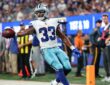 Dallas Cowboys running back Javonte Williams extends the ball as he crosses the goal line against the Giants.