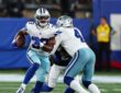 Cowboys running back Javonte Williams cuts upfield with the ball as a teammate blocks a Giants defender.