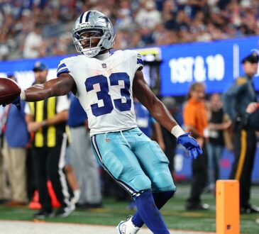 Dallas Cowboys running back Javonte Williams extends the ball as he crosses the goal line against the Giants.
