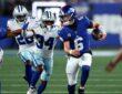 Giants quarterback Jaxson Dart scrambles upfield with the ball as Cowboys safety Jalen Thompson pursues.