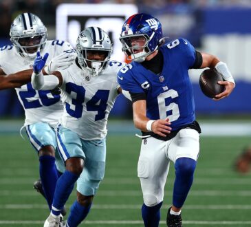 Giants quarterback Jaxson Dart scrambles upfield with the ball as Cowboys safety Jalen Thompson pursues.