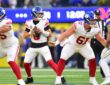 New York Giants quarterback Jaxson Dart holds the ball in the pocket as two offensive linemen block in front of him.