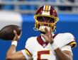 Commanders quarterback Jayden Daniels sets to throw during pregame warmups in a throwback helmet.