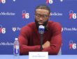 Philadelphia 76ers guard Jaylen Brown speaks at a table with a 76ers microphone and a nameplate reading Jaylen Brown.