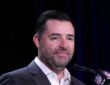 San Francisco 49ers owner Jed York smiles at a microphone with an NFL Network mic flag in front of him.