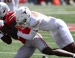Ohio State Buckeyes wide receiver Jeremiah Smith secures the ball as Texas defensive back Malik Muhammad drags him down.