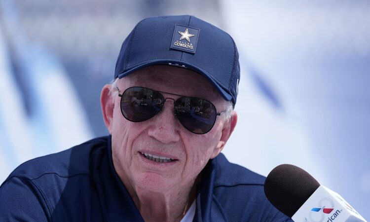 Dallas Cowboys owner Jerry Jones speaks into a microphone at the team's training camp opening press conference.
