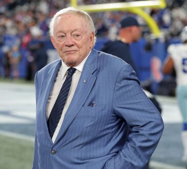 Cowboys owner Jerry Jones stands on the field with his hands on his hips before kickoff.