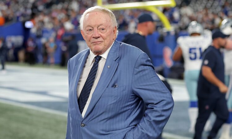 Cowboys owner Jerry Jones stands on the field with his hands on his hips before kickoff.