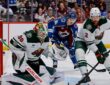Wild goaltender Jesper Wallstedt stops a puck at the post as defenseman Jeff Petry clears the rebound.